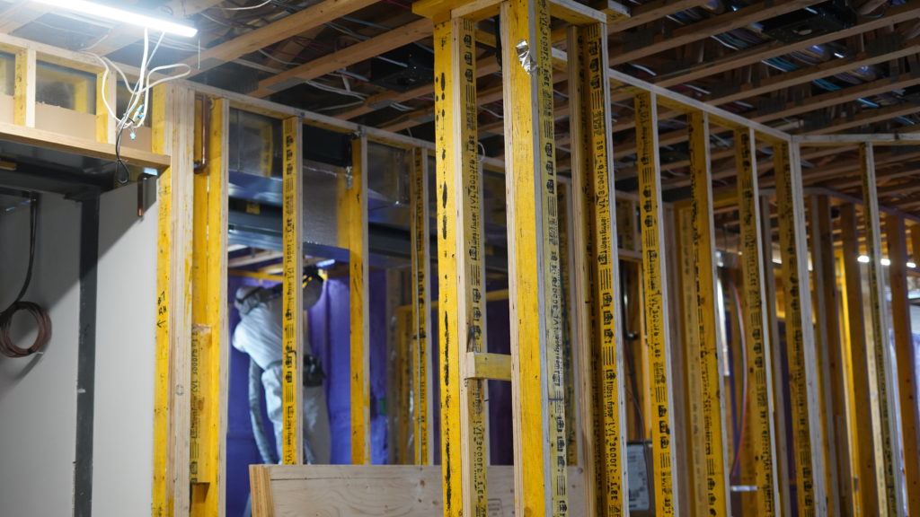 home renovation in basement with spray foam insulation installation